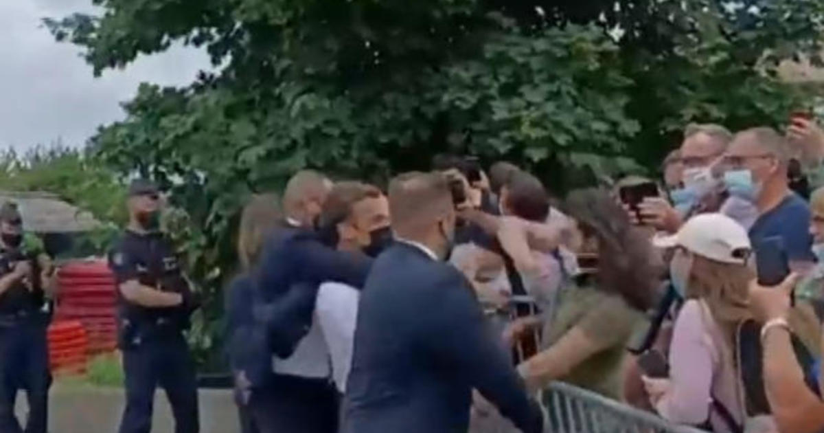 French President Emmanuel Macron slapped in face while greeting crowd - CBS News